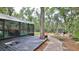 Backyard view of outdoor entertainment area with fire pit and outdoor shed at 1845 Spruce Creek Blvd, Port Orange, FL 32128