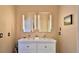 Bathroom with double sink vanity, modern lighting, and decorative accents at 1845 Spruce Creek Blvd, Port Orange, FL 32128