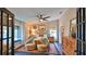 Bedroom showcasing tiled floors, ceiling fan, two lounge chairs, and window seat at 1845 Spruce Creek Blvd, Port Orange, FL 32128