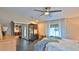 Bedroom showcasing a ceiling fan, tile floors, furnishings, and natural light from window at 1845 Spruce Creek Blvd, Port Orange, FL 32128