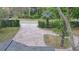 View of a multicolored brick driveway that is surrounded by manicured landscaping at 1845 Spruce Creek Blvd, Port Orange, FL 32128