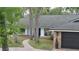 Charming single-story home featuring light blue siding and a brick-lined driveway at 1845 Spruce Creek Blvd, Port Orange, FL 32128