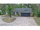 Charming single-story home with a brick-lined driveway and a two-car garage at 1845 Spruce Creek Blvd, Port Orange, FL 32128
