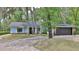 Charming single-story home featuring light blue siding and a brick-lined driveway at 1845 Spruce Creek Blvd, Port Orange, FL 32128