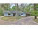 Charming single-story home featuring light blue siding and a brick-lined driveway at 1845 Spruce Creek Blvd, Port Orange, FL 32128