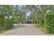 Charming single-story home featuring light blue siding and a brick-lined driveway at 1845 Spruce Creek Blvd, Port Orange, FL 32128