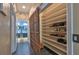 Hallway view of large shelved storage area and double sink bathroom at 1845 Spruce Creek Blvd, Port Orange, FL 32128