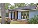 Charming home featuring light blue siding, black window trim and a brick-lined entrance at 1845 Spruce Creek Blvd, Port Orange, FL 32128