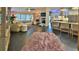 Open-concept living area with modern tile floors, fireplace, and kitchen bar at 1845 Spruce Creek Blvd, Port Orange, FL 32128
