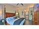 Bedroom showcasing a spacious layout with a four-poster bed and ensuite access at 1845 Spruce Creek Blvd, Port Orange, FL 32128