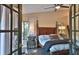 Bedroom featuring tile floors, four poster bed, and an outdoor view at 1845 Spruce Creek Blvd, Port Orange, FL 32128