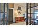 Office area with a desk, decor, and built-in shelving, connected to another room with glass doors at 1845 Spruce Creek Blvd, Port Orange, FL 32128