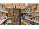 Walk-in pantry with custom wood shelving and wrought iron wine storage at 1845 Spruce Creek Blvd, Port Orange, FL 32128