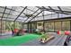 Bright sunroom with comfortable seating and a ceiling fan for relaxing indoor/outdoor living at 1845 Spruce Creek Blvd, Port Orange, FL 32128