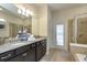 Modern bathroom with granite countertops, double sinks, and a glass-enclosed shower at 1876 Nice Ct, Kissimmee, FL 34747