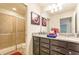 Bathroom with double sink vanity with granite counters and tiled shower at 1876 Nice Ct, Kissimmee, FL 34747