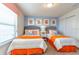 Bedroom features two twin beds, window with blinds, and matching decor at 1876 Nice Ct, Kissimmee, FL 34747