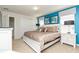 Bedroom features a large bed, side tables, modern lamps, and art at 1876 Nice Ct, Kissimmee, FL 34747