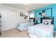 Bedroom features two twin beds, Disney themed wall art and decor at 1876 Nice Ct, Kissimmee, FL 34747