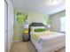 Bedroom features a bed, side table, window, and modern decor at 1876 Nice Ct, Kissimmee, FL 34747