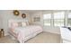 Bedroom with a bed, large window with blinds, side table, and modern decor at 1876 Nice Ct, Kissimmee, FL 34747