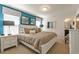 Bedroom features a large bed, side tables, modern lamps, and art at 1876 Nice Ct, Kissimmee, FL 34747