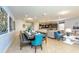 Open-concept dining area with long table set, flowing into a kitchen and living room at 1876 Nice Ct, Kissimmee, FL 34747
