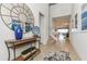 Bright foyer with decorative mirror, console table, and view of the living spaces at 1876 Nice Ct, Kissimmee, FL 34747