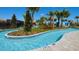 Lush landscaping surrounds this tranquil lazy river, inviting residents to relax and enjoy at 1876 Nice Ct, Kissimmee, FL 34747