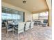 Covered patio features dining and lounging areas overlooking the meticulously maintained backyard space at 1876 Nice Ct, Kissimmee, FL 34747