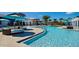 Community pool with lounge chairs, pergolas, and umbrellas at 1876 Nice Ct, Kissimmee, FL 34747