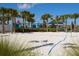 Beach volleyball court lined with palm trees and grass at 1876 Nice Ct, Kissimmee, FL 34747