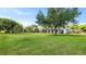 Large, meticulously maintained backyard with established trees, complemented by a screened-in patio at 2218 Ridgewind Way, Windermere, FL 34786
