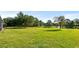 Oversized backyard, featuring a serene water view and lush lawn, perfect for outdoor activities at 2218 Ridgewind Way, Windermere, FL 34786