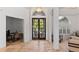 Bright foyer features double doors, arched windows, and neutral-toned tile flooring at 2218 Ridgewind Way, Windermere, FL 34786
