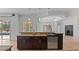 Spacious kitchen island featuring dark wood cabinets, granite countertops, and a built-in beverage cooler at 2218 Ridgewind Way, Windermere, FL 34786