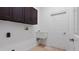 Practical laundry room featuring a utility sink, storage cabinets, and a clean, functional space at 2218 Ridgewind Way, Windermere, FL 34786