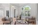 Cozy living room featuring neutral tones, large windows, and ample seating at 2218 Ridgewind Way, Windermere, FL 34786