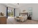 Inviting main bedroom with neutral tones, a tray ceiling, and sliding doors to the outdoor pool area at 2218 Ridgewind Way, Windermere, FL 34786