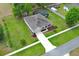Overhead shot of house showing the screened-in pool and green lawn at 30413 Plymouth Creek Cir, Sorrento, FL 32776