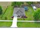 Aerial view of the home, showing the screened pool, landscaping, and driveway at 30413 Plymouth Creek Cir, Sorrento, FL 32776