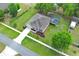 Aerial view of home with manicured lawn, charming landscaping, and screened-in pool at 30413 Plymouth Creek Cir, Sorrento, FL 32776
