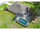 Aerial view of the home with a pool and enclosure at 30413 Plymouth Creek Cir, Sorrento, FL 32776