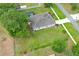 Aerial view of a home with a large yard, pool, and long driveway at 30413 Plymouth Creek Cir, Sorrento, FL 32776