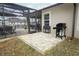 Cozy backyard firepit and lounge area near a screened-in pool for outdoor enjoyment and entertaining at 30413 Plymouth Creek Cir, Sorrento, FL 32776