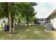 Expansive backyard featuring a fire pit area and screened-in pool enclosure at 30413 Plymouth Creek Cir, Sorrento, FL 32776