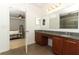 Elegant bathroom with double sinks, granite counters, and tiled floors at 30413 Plymouth Creek Cir, Sorrento, FL 32776