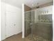 Bathroom showing a glass-enclosed shower with overhead rain shower fixture and hand-held wand, and a tiled shower stall at 30413 Plymouth Creek Cir, Sorrento, FL 32776