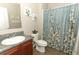 Bathroom vanity with granite countertop, decorative mirror and wall art and tiled flooring with a bathtub in the background at 30413 Plymouth Creek Cir, Sorrento, FL 32776