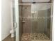 Bathroom showing a glass-enclosed shower with overhead rain shower fixture and hand-held wand, and a tiled shower stall at 30413 Plymouth Creek Cir, Sorrento, FL 32776